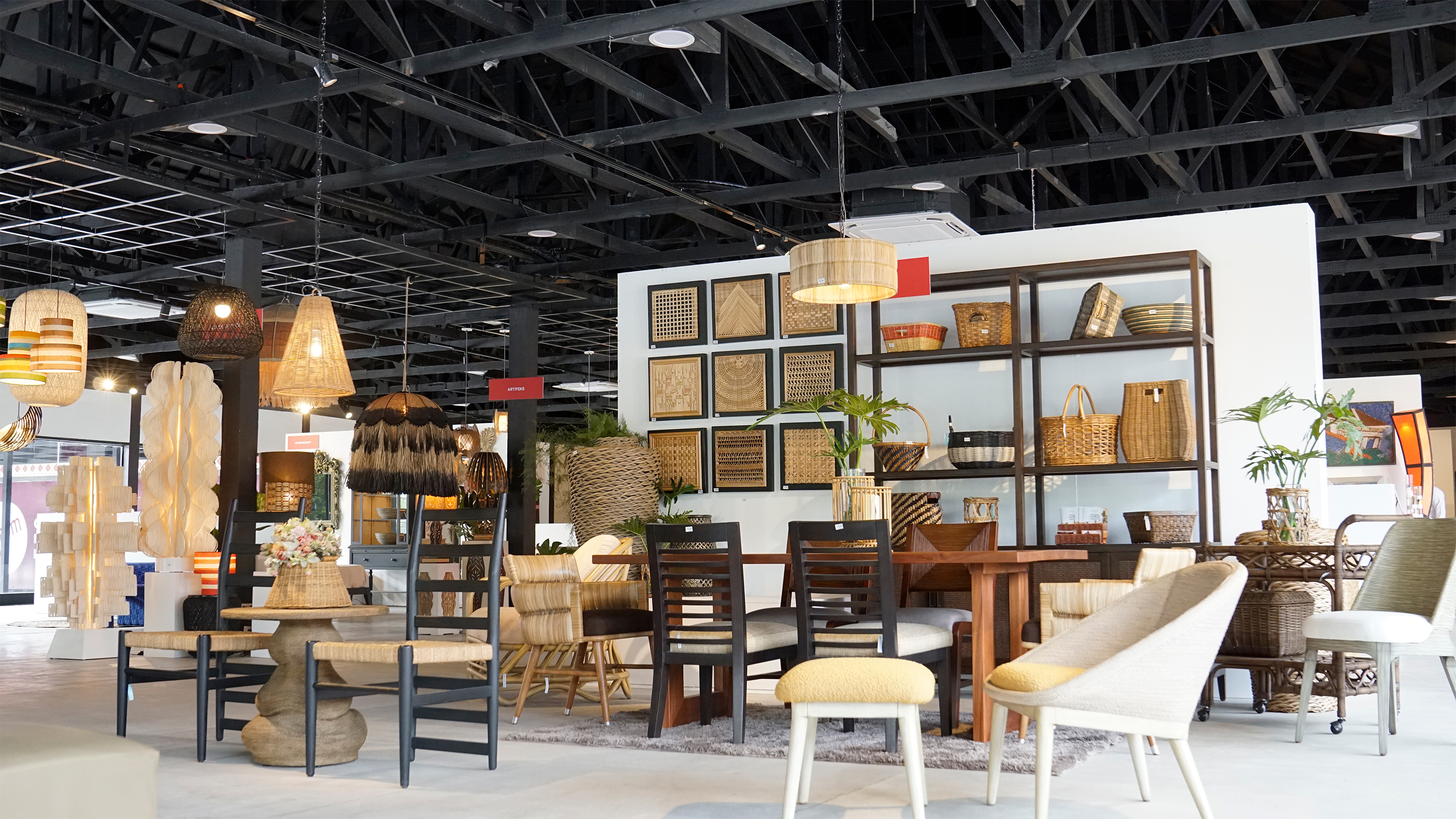 Display shelves filled with woven baskets and handcrafted wall panels.